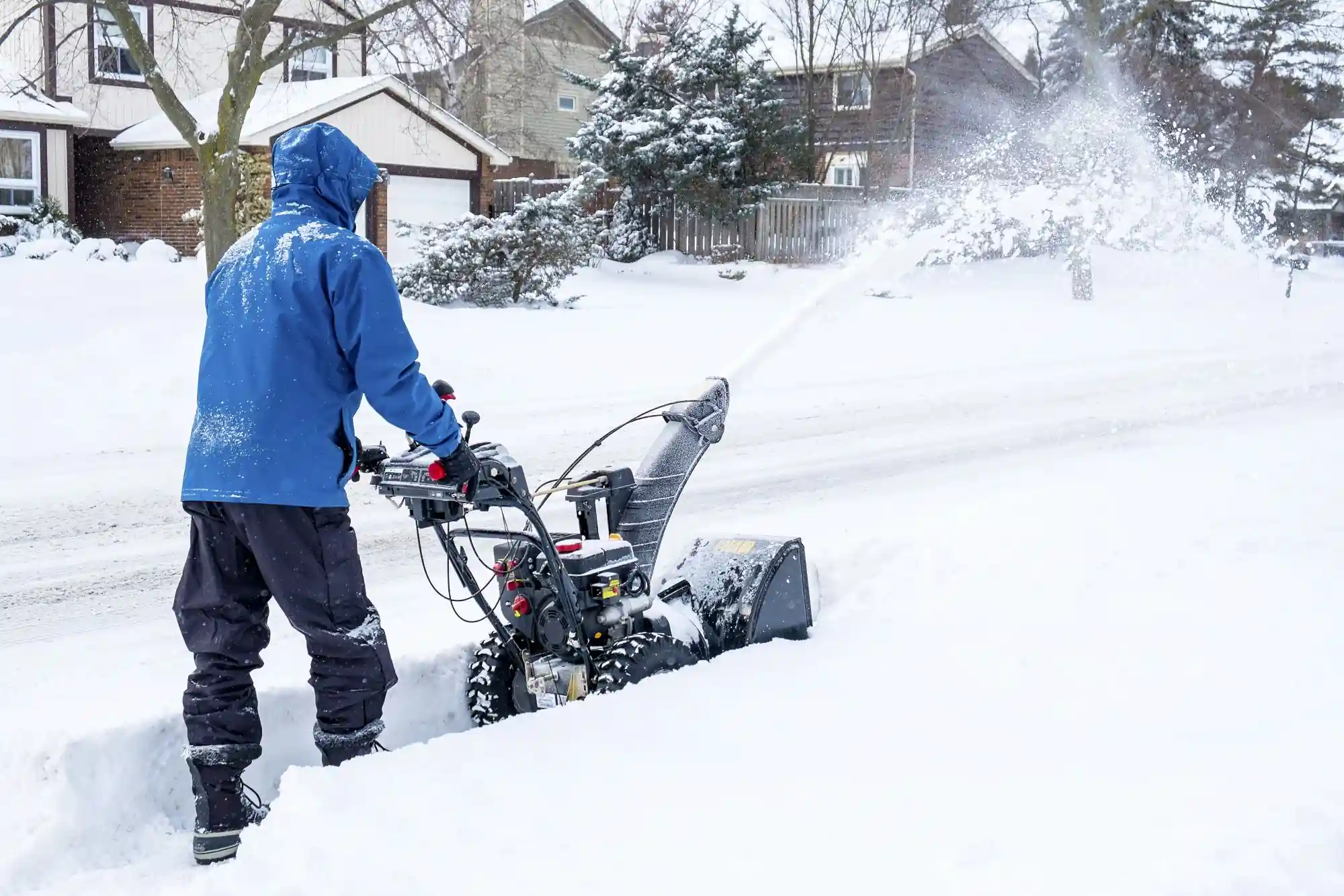 A man running a snowblower.